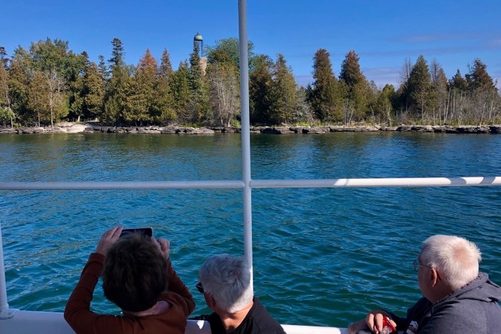 a group of people standing in front of a body of water