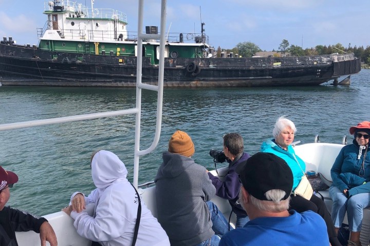 a group of people in a boat on a body of water