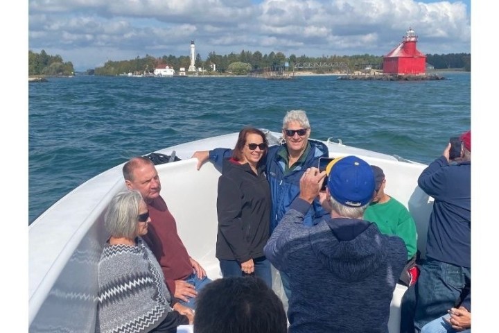 a group of people standing in front of a body of water