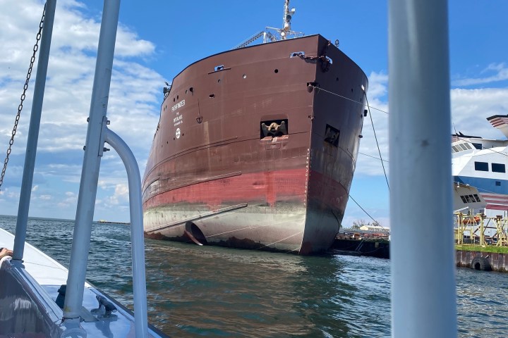 a close up of a boat next to a body of water