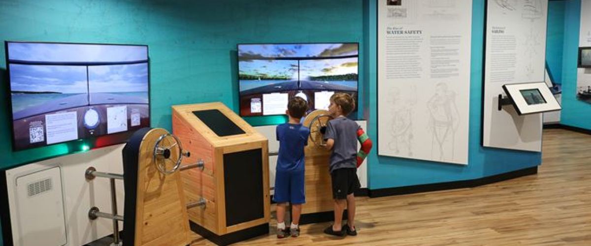 a group of people standing in front of a computer