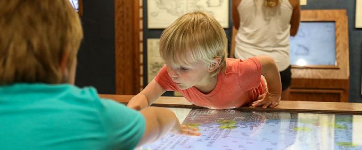a young boy sitting at a table