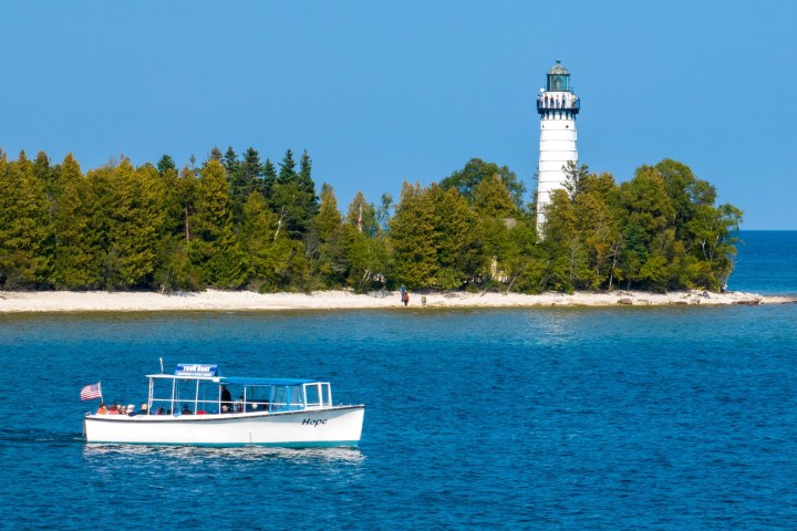 a blue and white boat floating on a body of water