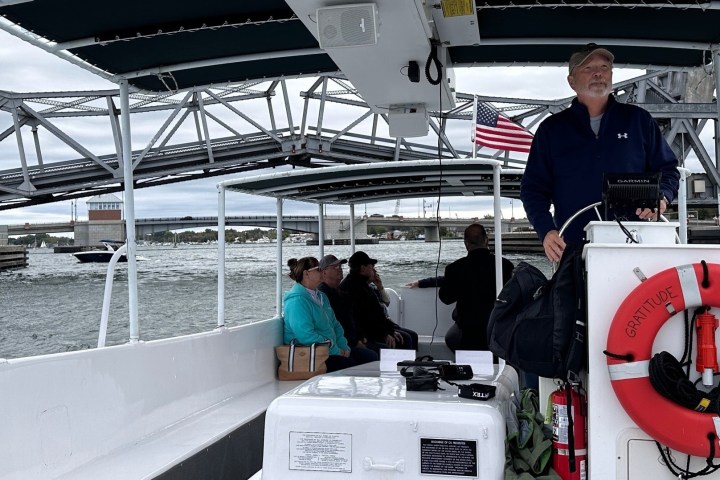 a man standing next to a bridge