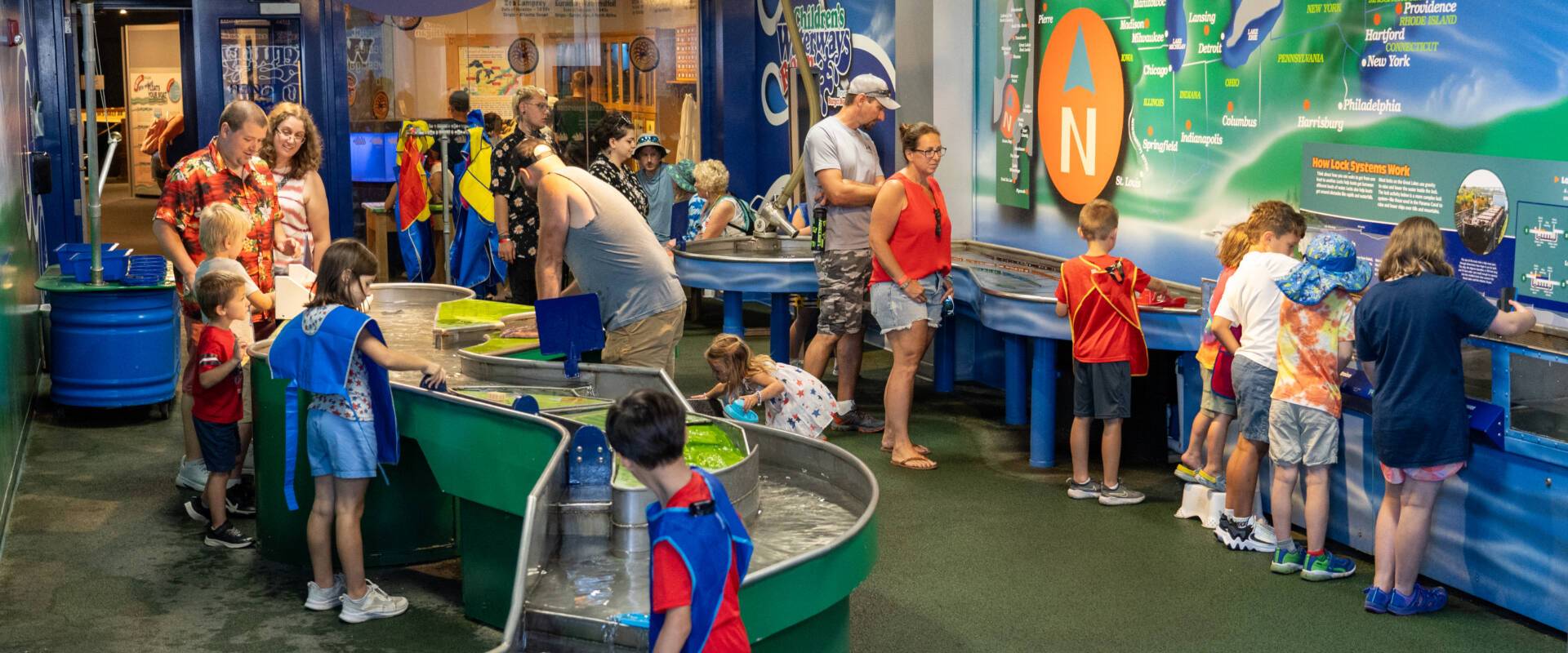 a group of adults and children inside an interactive exhibit at Wisconsin Maritime Museum