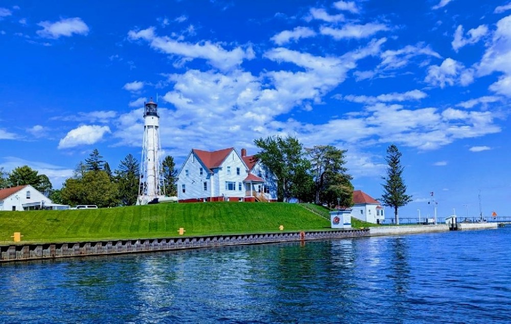 a large body of water in front of a lighthouse