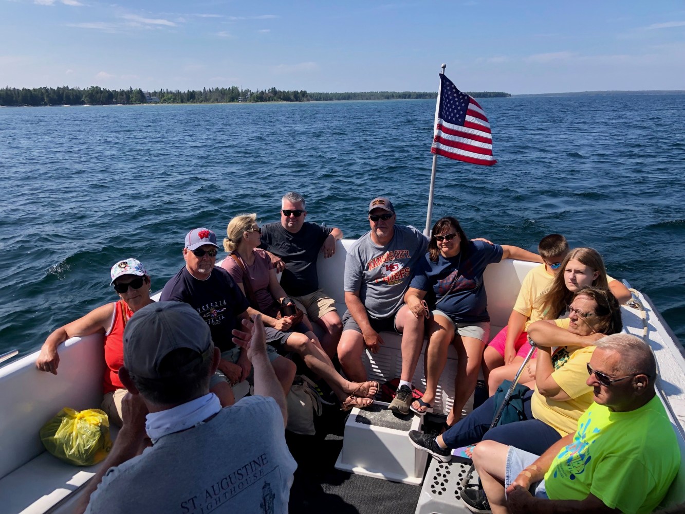 a group of people in a boat on a body of water