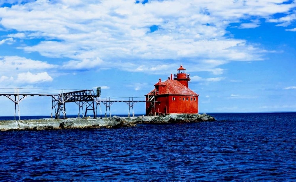 a light house next to a large body of water