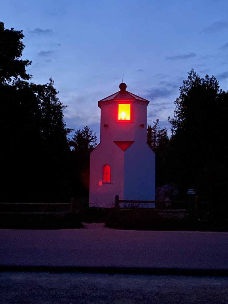 the range light of baileys harbor lit up at night