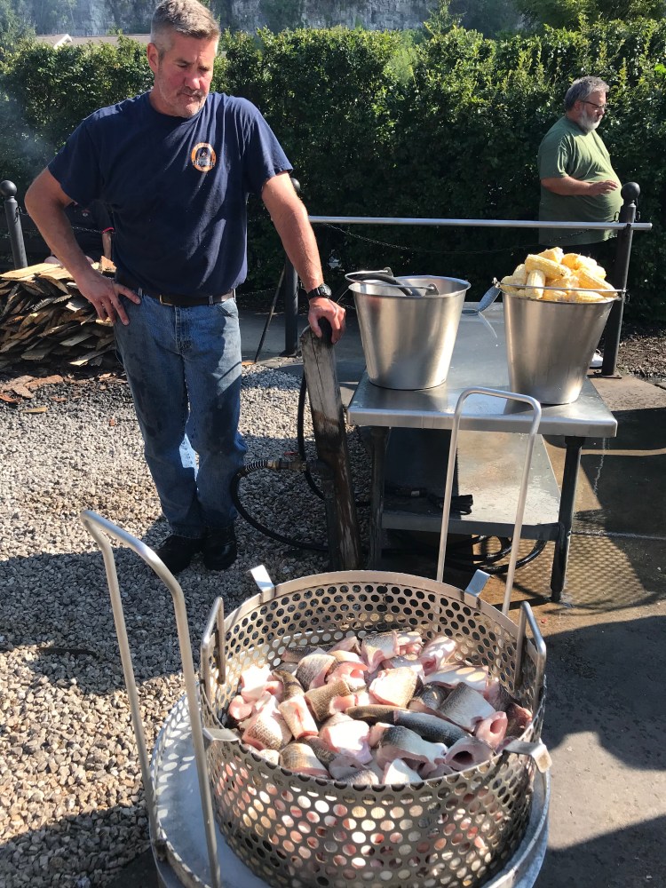 a man cooking a traditional door county fish boil