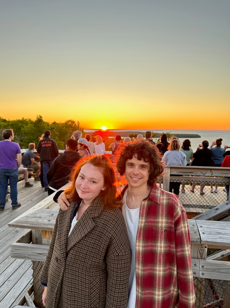 a man and a woman enjoying the sunset on Eagle Tower in Peninsula State park