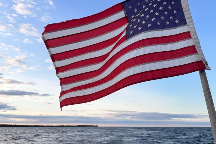 a flag next to a body of water